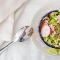 Pozole De Pollo  · Hominy soup with shredded chicken and topped with lettuce sliced radish and oregano.