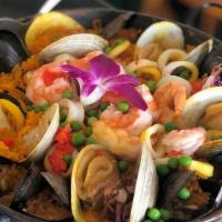 Paella Valenciana · Gluten-free. Mussels, clams, shrimp, scallops, chicken, chorizo. Paella - Spain's classic sa...