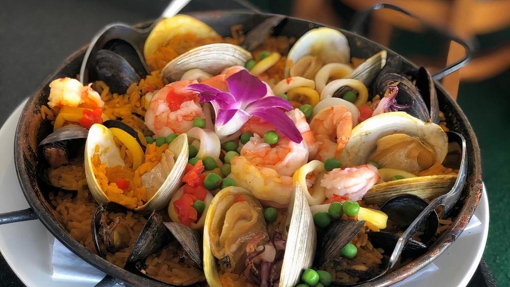 Paella Valenciana · Gluten-free. Mussels, clams, shrimp, scallops, chicken, chorizo. Paella - Spain's classic saffron rice dish.