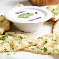 Garlic Naan · Unleavened bread topped with fresh garlic.