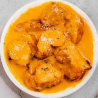 Butter Chicken · Boneless roasted tandoori chicken cooked with onion, tomato sauce and heavy cream.