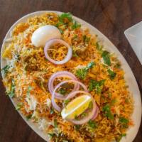 Chicken Biryani · Chicken and rice with onion.