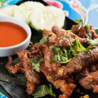 Moo Dad Deaw · Special Thai style fried sun-dried pork marinated in sauce, salt, fish sauce, sugar served w...