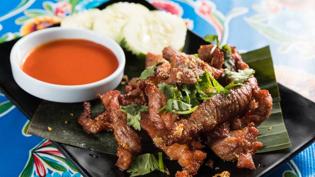 Moo Dad Deaw · Special Thai style fried sun-dried pork marinated in sauce, salt, fish sauce, sugar served with sriracha sauce.