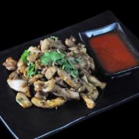 Pad Kra Thiem Prik Thai · Wok stir-fried with garlic, black pepper with roasted garlic sauce. Served with rice and Tha...