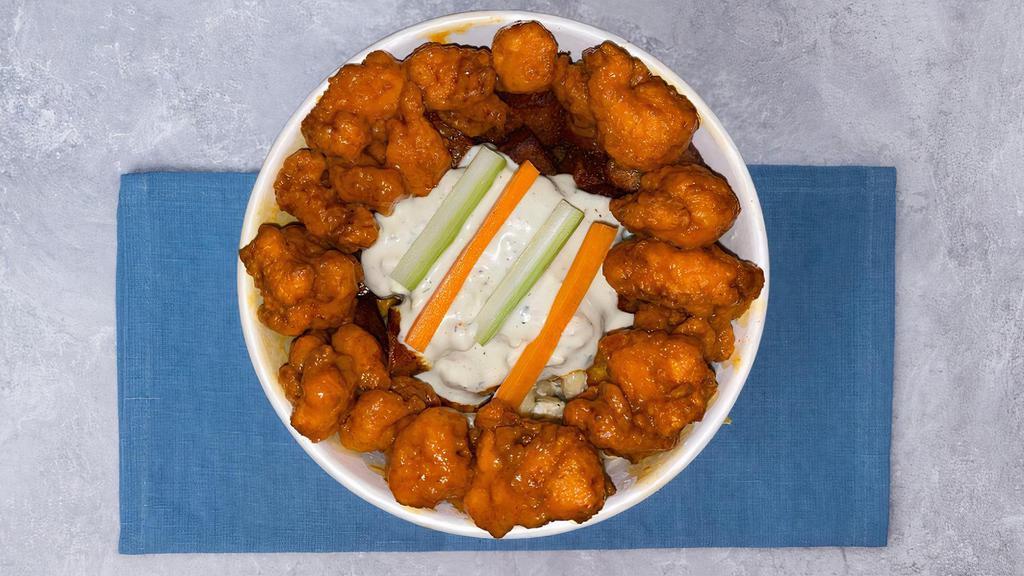 The Buffalo Bowl  · Creamy Mac salad and crispy home fries below Buffalo chicken bites. Topped with our house-made blue cheese, garnished with petite carrot & celery sticks.