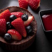 Chocolate Souffle · Chocolate soufflé, fresh berries, raspberry sauce