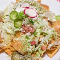 Nachos Deluxe · Fresh homemade chips topped with melted cheese, refried beans, lettuce, soar cream, jalapeno...