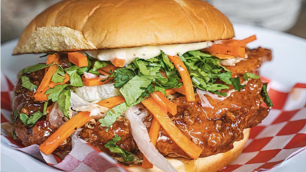 Sweet Chili Glazed Chicken Sandwich · *Our New Special*. Sweet Chili Glazed Chicken on a potato bun topped with iceberg lettuce,  pickled carrots, cilantro and lime mayo