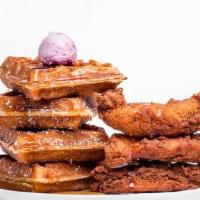 Classic Chicken Tenders & Waffles · 4 boneless chicken tenders paired with a full waffle. Served with hot sauce, maple syrup, an...