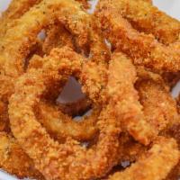 Fried Calamari · Golden, crispy on the outside, tender on the inside, and squid rings. Served on shredded let...