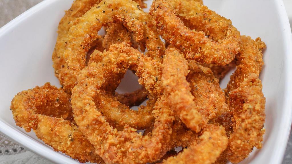 Fried Calamari · Golden, crispy on the outside, tender on the inside, and squid rings. Served on shredded lettuce and sweet chili sauce on the side.