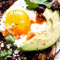 Huevos Rancheros · 2 fried eggs, sharp cheddar, refried beans, black beans, tortilla, tomato salsa, cojito chee...
