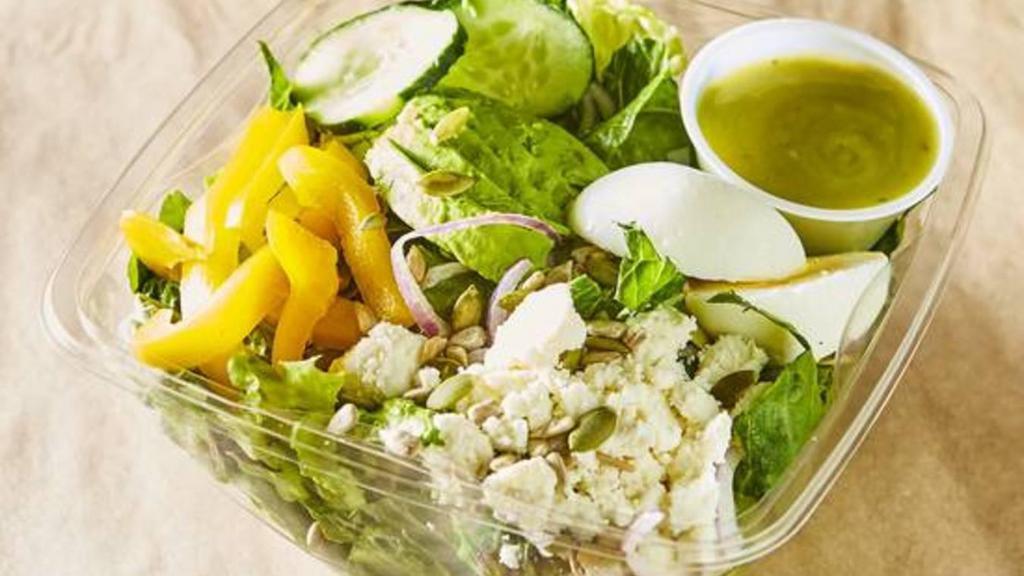Avocado Green Goddess Salad · Crisp romaine tossed with avocado, feta, bell peppers, cucumbers, eggs, and red onions.  We add some mixed seeds for crunch and serve with avocado green goddess dressing.(Salad-480 calories, Dressing 60 calories for 2 fl oz)