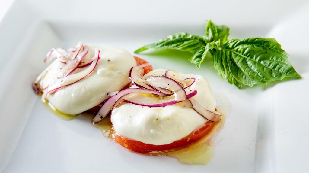 Caprese · Homemade mozzarella, tomato, and onions with extra virgin olive oil and basil.