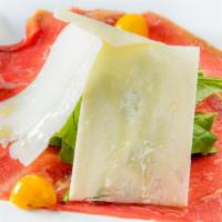 Carpaccio Di Manzo · Thinly sliced cured beef with arugula and shaved parmesan cheese.