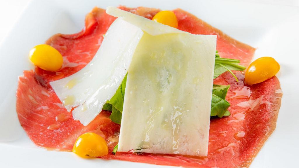 Carpaccio Di Manzo · Thinly sliced cured beef with arugula and shaved parmesan cheese.