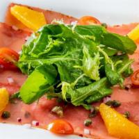 Carpaccio Di Tonno · Sushi-grade, thinly sliced cured tuna with capers, onions, extra virgin olive oil, and lemon...