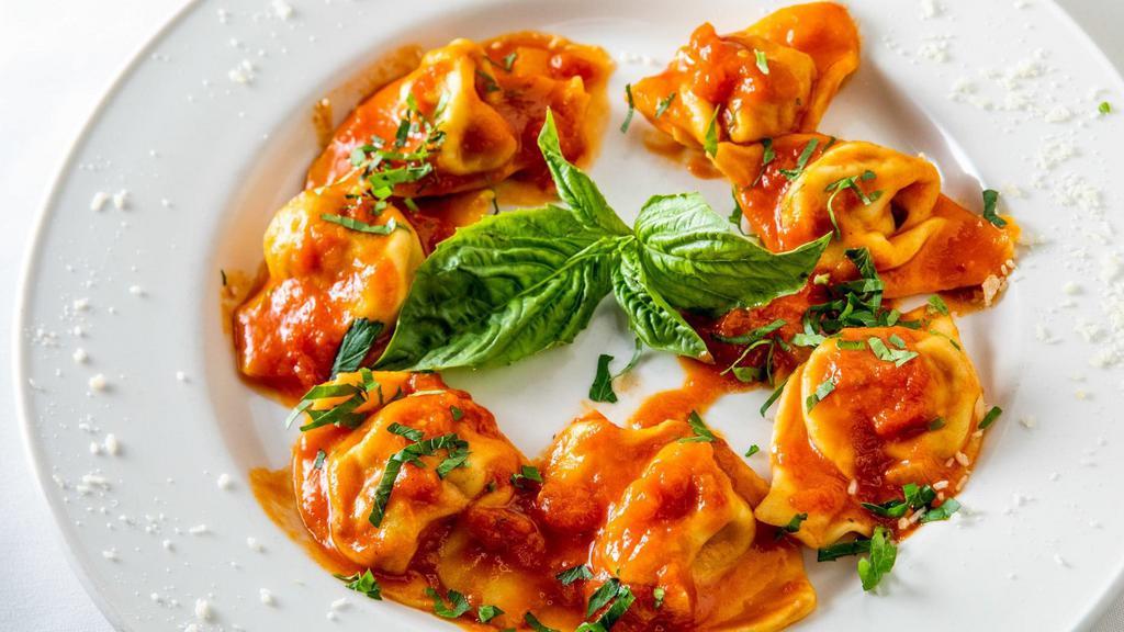 Tortelloni Al Pomodoro · Homemade large tortellini filled with veal and chicken in a tomato sauce.