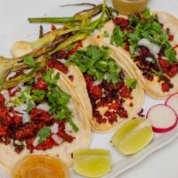 Carnitas Taco · Confit pork in a soft corn tortilla topped with cilantro and dice onions. You have the choic...