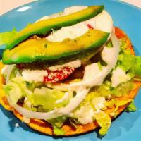 Bistec Tostadas · Thin Sliced Steak.Hard Corn Tortilla  Topped with Lettuce, Sour Cream, Refried Beans, Avocad...