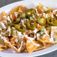 Regular Nachos · Popular item. Tortilla chips, refried beans, melted cheese, pico de gallo, sour cream, and j...