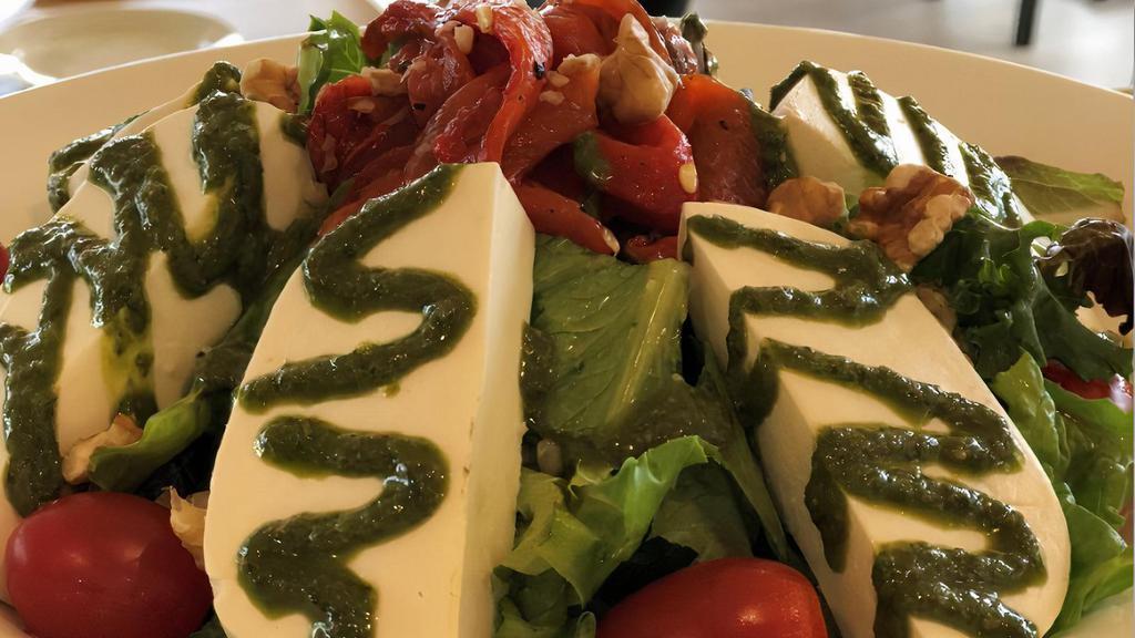 Fresh Mozzarella Salad · Mix greens and lettuce, roasted peppers, tomato, basil pesto, walnuts and herbs tossed with balsamic sauce.