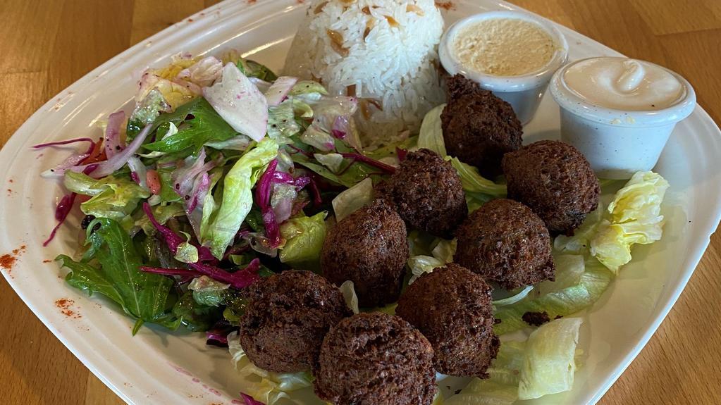 Falafel Dinner Plate · Chickpeas, celery, parsley, onion, cumin, black pepper and salt, deep-fried. Served with rice, salad and hummus tahini sauce.