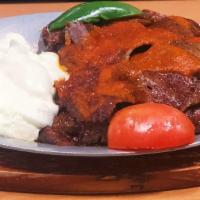 Iskender Kebab · This most popular dish of Turkish cuisine is made with tender slices of lamb gyro layered on...