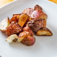 Potatoes · Garlic roasted with herbs.