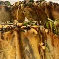 Roast Duck Roll · Boneless roast duck on scallion pancake with avocado,  spring mix, and drizzled with teriyak...