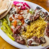 Shish Kebob Plate · A salad base topped with two skewers of lamb. Most plates are served with pita bread on the ...