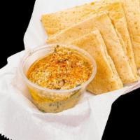 Baba Ghanoush Dishes · A garnished plate of baba ghanoush. Most plates are served with pita bread on the side.