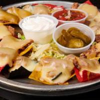 Nacho Bites · Nearly a dozen individual nacho chips topped with refried beans and melted muenster cheese, ...
