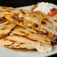 Steak Quesadilla · Filled with thinly sliced prime rib of beef, Monterey Jack and cheddar cheeses, served with ...