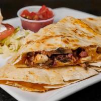 Rockwells Quesadilla · Filled with chunks of grilled chicken, bacon, mushrooms, Monterey Jack, and cheddar cheeses,...