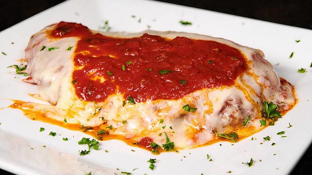 Chicken Parmigiana · Tender breaded chicken breast, topped with marinara sauce and covered with melted mozzarella cheese, served with choice of side.