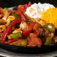 Rockwells Combo Sizziling Fajitas · A sizzling platter of grilled chicken and steak, with sauteed onions, tomatoes and peppers i...