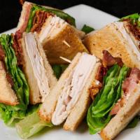 Turkey Club Sandwich · Triple decker toasted white bread sandwich with turkey, bacon, lettuce, tomato and mayo.