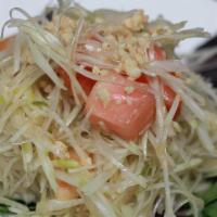 Green Papaya Salad · Green papaya with tomatoes, minced string beans, and topped with ground peanuts and spicy li...