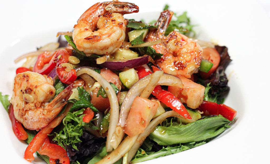 Grilled Shrimp Salad · Grilled shrimp with mixed greens, tomatoes, bell pepper, cucumber, onion, thai herbs, and chili lime juice. Spicy lowest level mild.