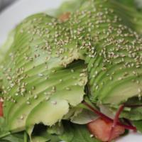 Avocado Salad · Mixed greens and avocado with ginger citrus dressing and sesame seeds on top.