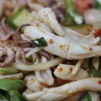 Calamari Salad · Steamed calamari, mixed greens, tomatoes, bell peppers, lemongrass, onions, mint leaves, and...