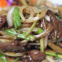 Mongolian Beef · Spicy. Sauteed beef with onion and scallion over a bed of crispy noodles. Served with steame...