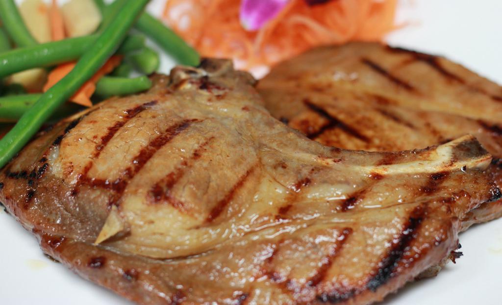 Lemongrass Pork Chop · Grilled thin slices of pork chops marinated with lemongrass, galangal garlic, and lime juice. Served with steamed jasmine rice.