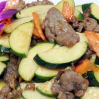 Zucchini Beef · Sauteed beef with zucchini and carrots in a light garlic sauce. Served with steamed jasmine ...
