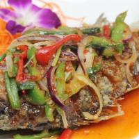Striped Bass Chili · Whole deep fried striped bass topped with chili, onions, scallions, bell pepper, tamarind, a...