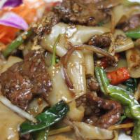 Drunken Noodles · Stir fried flat rice noodles with bell pepper, onion, basil, egg, scallion, and spicy chili ...
