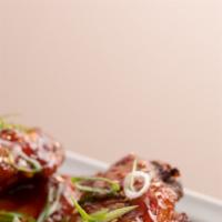 Crispy Korean Style Wings · fried chicken wings, gochujang sauce, fresh scallions, sesame seeds