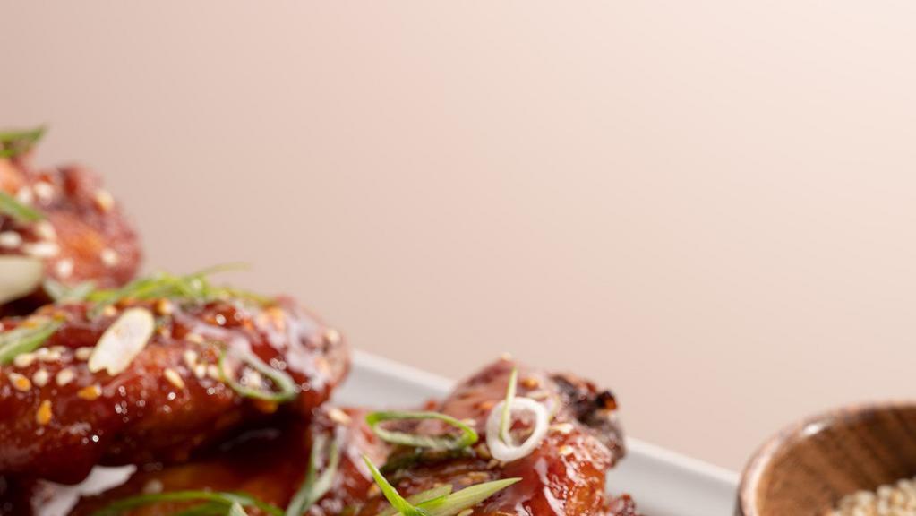 Crispy Korean Style Wings · fried chicken wings, gochujang sauce, fresh scallions, sesame seeds